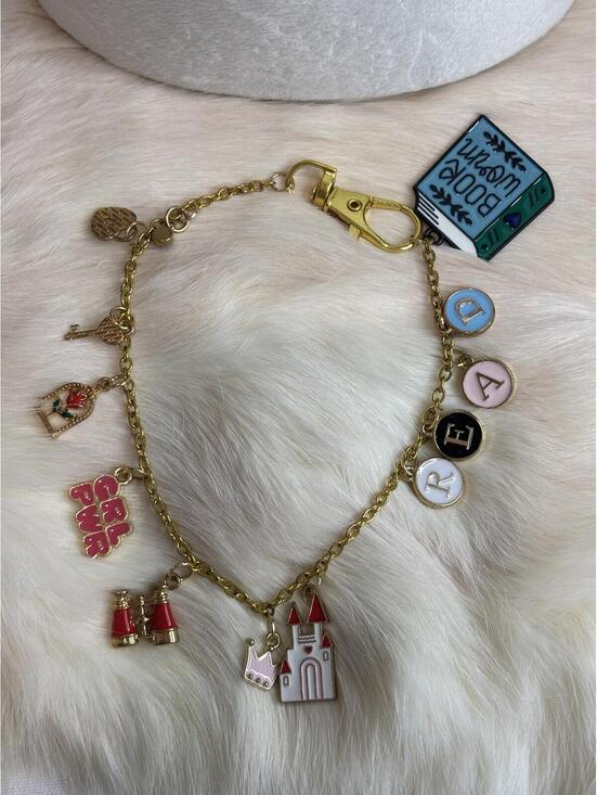Other - Gold Tone bag Charm with Book, Castle, and Girl Power Charms